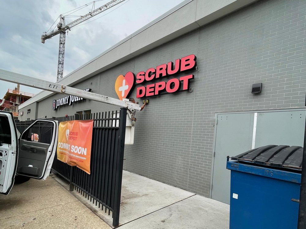 Scrub Depot channel letters and logo being installed on a masonry wall